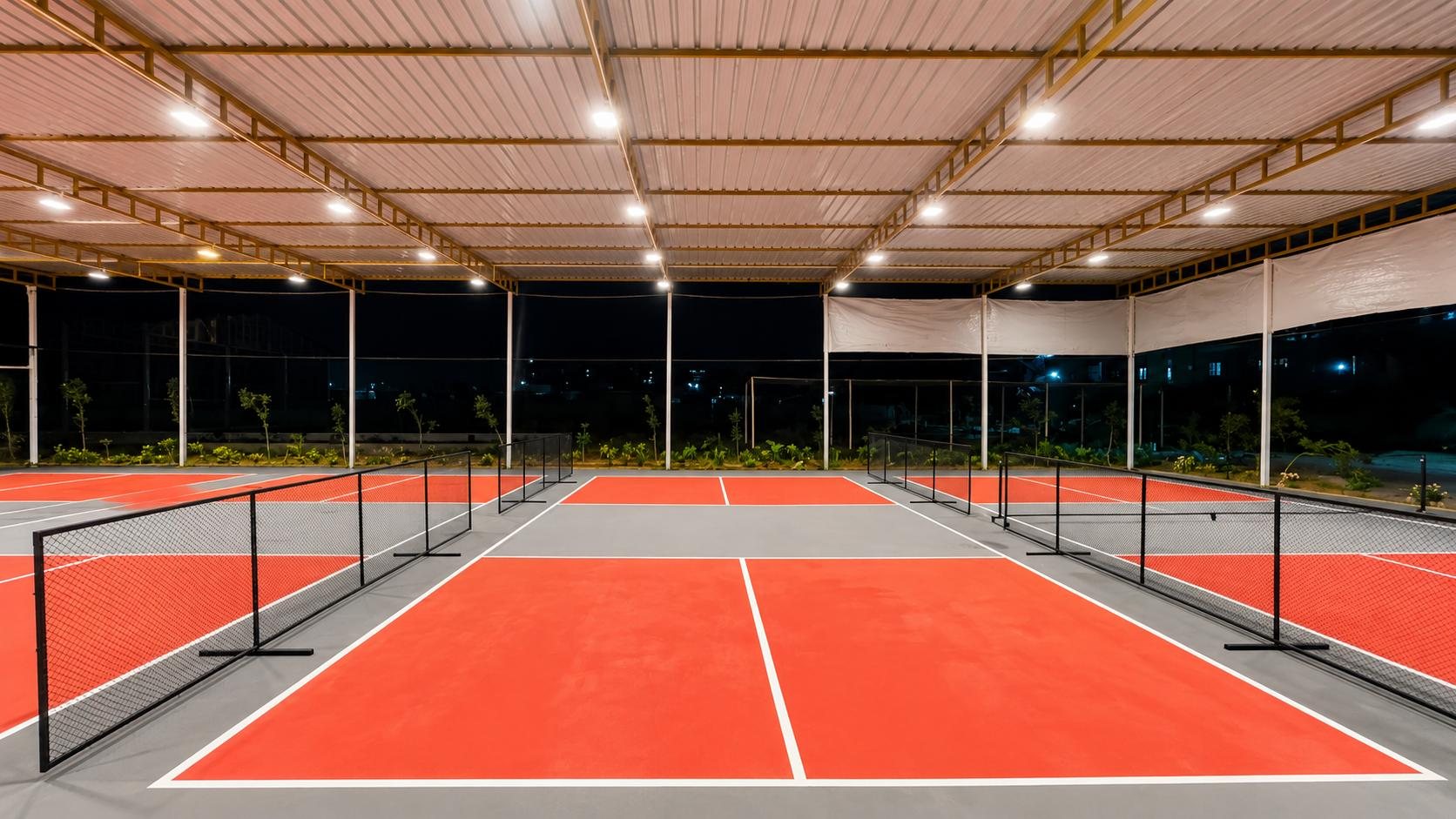 Four covered, floodlit pickleball courts at Lakeside Pickle Club, Whitefield
